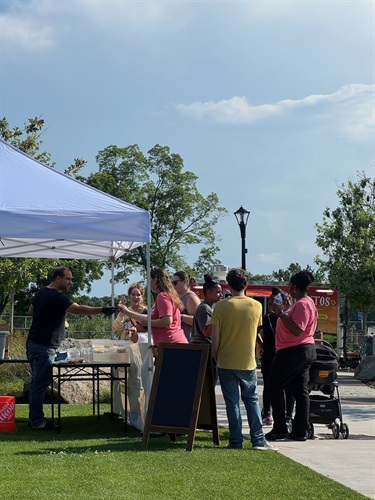 Line at a vendor booth at the Church St Farmers Market